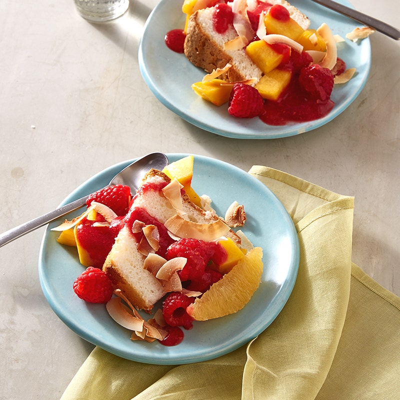 Angel food cake with tropical fruit salad and raspberry sauce