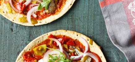 Baked flatbread with sardines and arugula