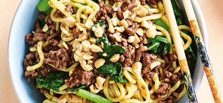 Sticky beef with noodles and greens