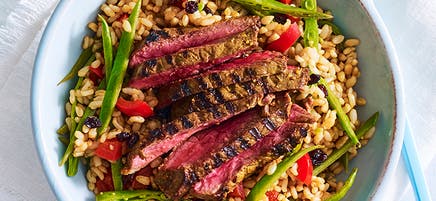 Turmeric, honey and sesame marinated beef with warm brown rice salad