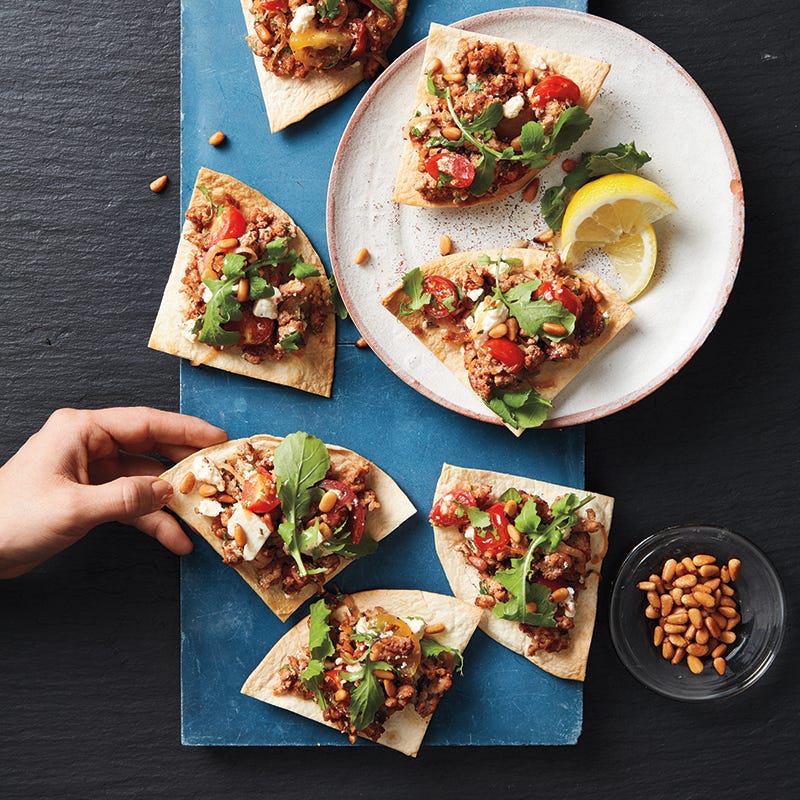 Turkey tortilla wedges with arugula and pine nuts