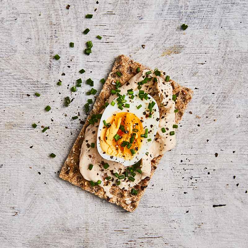 Crispbread topped with onion dip and egg