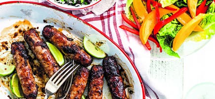 Jerk sausages with mango salad & rice