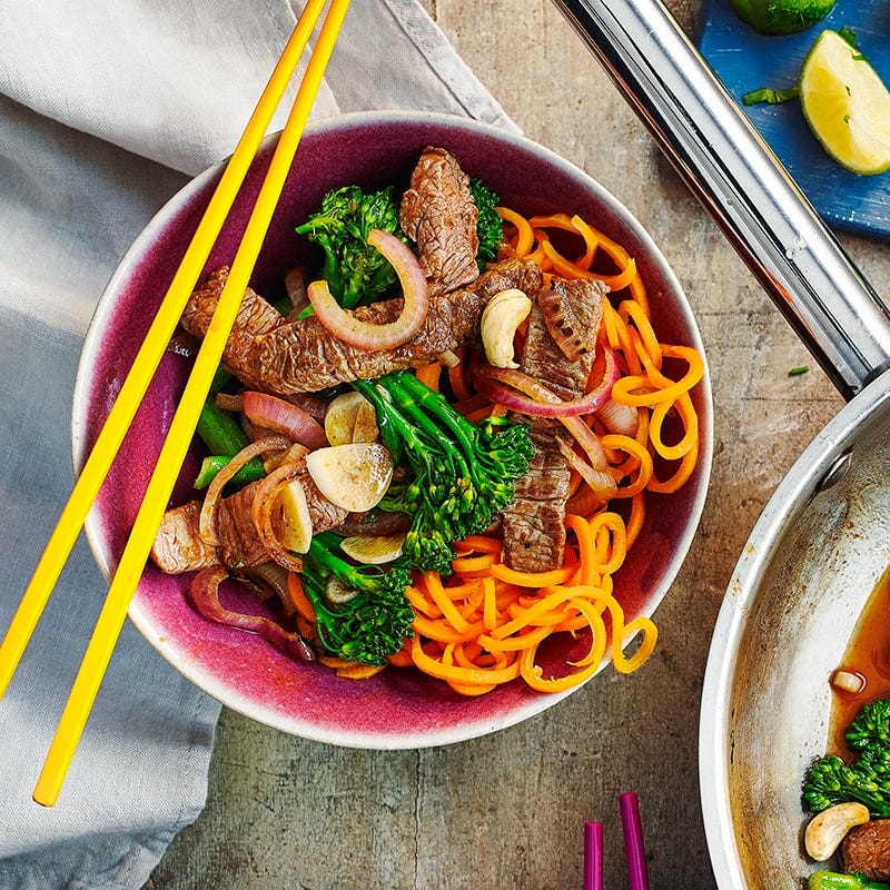 Spicy stir-fried beef and broccoli with carrot noodles