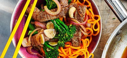 Spicy stir-fried beef and broccoli with carrot noodles