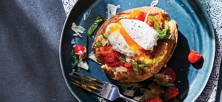 Baked potato with saucy tomatoes and poached egg
