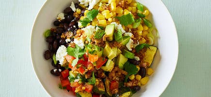 Mexican black bean, zucchini and corn bowl with cumin-lime drizzle