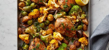 Garlic chicken with cauliflower, potatoes and olives tray bake