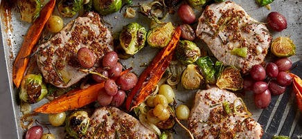 Rosemary pork with sweet potato, sprouts and grapes tray bake