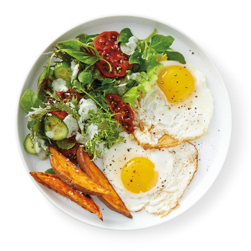 Photo of Fried eggs with roasted sweet potato wedges and mixed greens by WW
