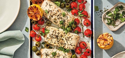 Grilled halibut with charred tomatoes, lemons, and olives