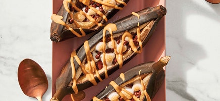Grilled banana split boats with peanut butter sauce