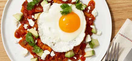 Chilaquiles with fried eggs, cheese, and avocado