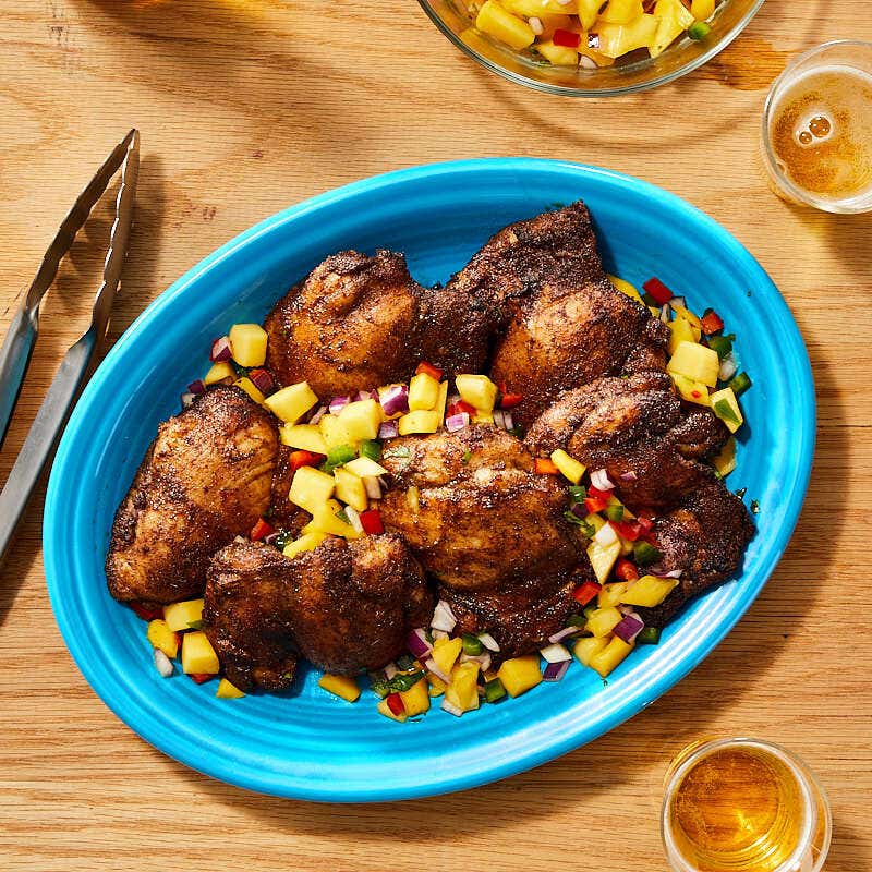 Jerk chicken thighs with fresh mango salsa by Millie Peartree