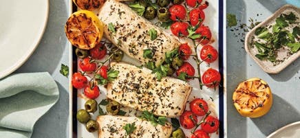 Grilled halibut with charred tomatoes, lemons, and olives