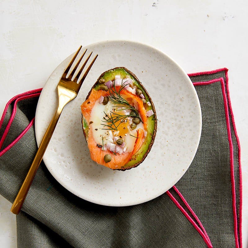 Egg baked in avocado with smoked salmon, capers and dill