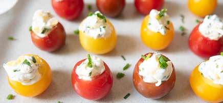 Creamy corn and herb–stuffed cherry tomatoes