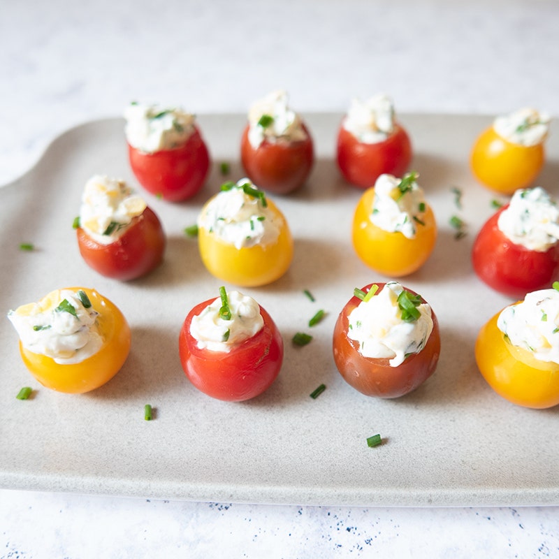 Creamy corn and herb–stuffed cherry tomatoes