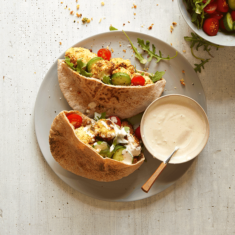 Crumbed air-fryer cauliflower pitas with tahini sauce