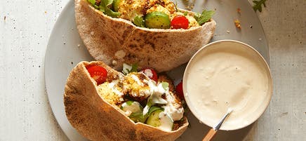 Crumbed air-fryer cauliflower pitas with tahini sauce