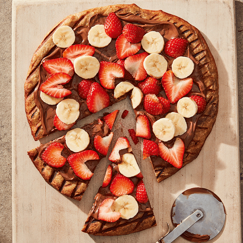 Hazelnut chocolate pizza with bananas and strawberries