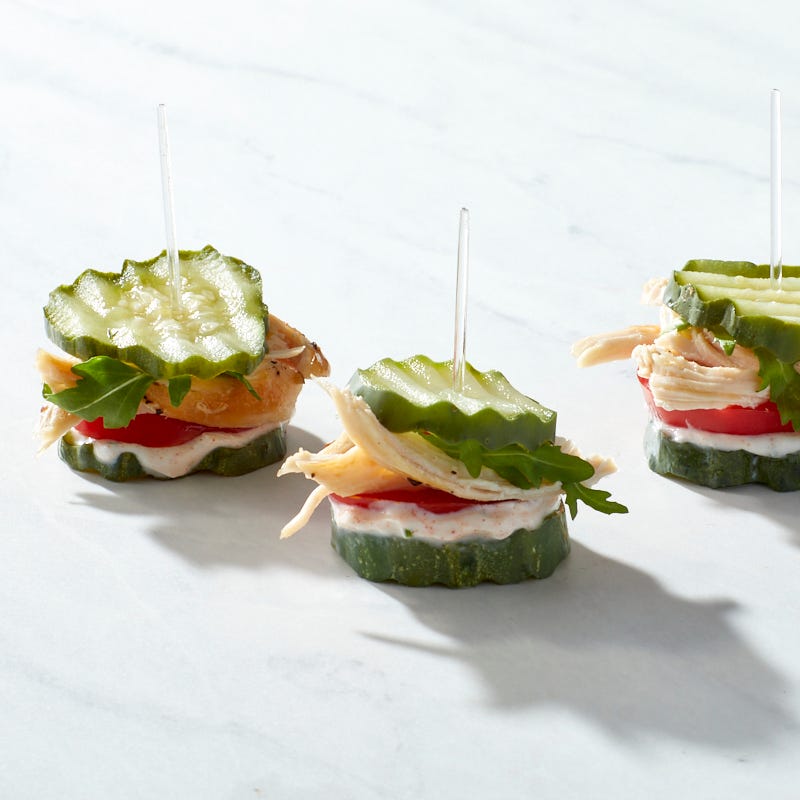 sliced chicken, tomato, arugula and chive yogurt sandwiched between dill pickle chips