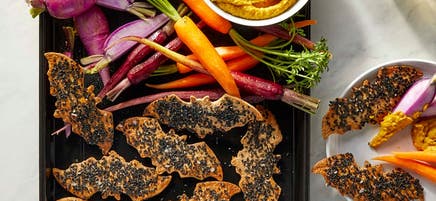 Spooky sesame tortilla chips with pumpkin hummus