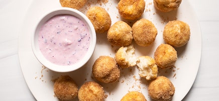 Air-fried donut holes with creamy berry sauce