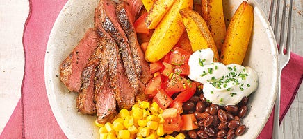 Steak bowl with wedges and sour cream