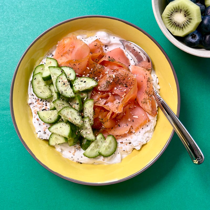 Bowl of yoghurt, smoked salmon, and cucumbers